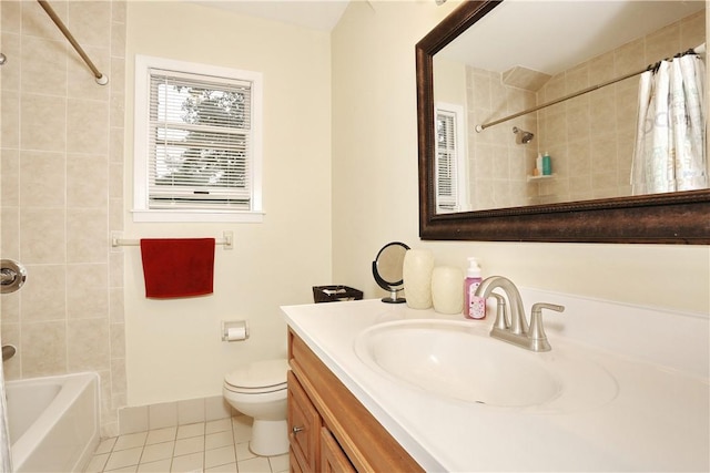 full bathroom featuring toilet, vanity, tile patterned floors, and shower / bathtub combination with curtain