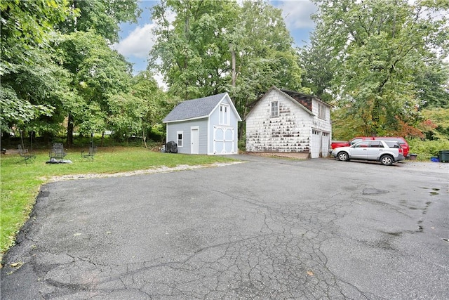 exterior space with a garage and a lawn