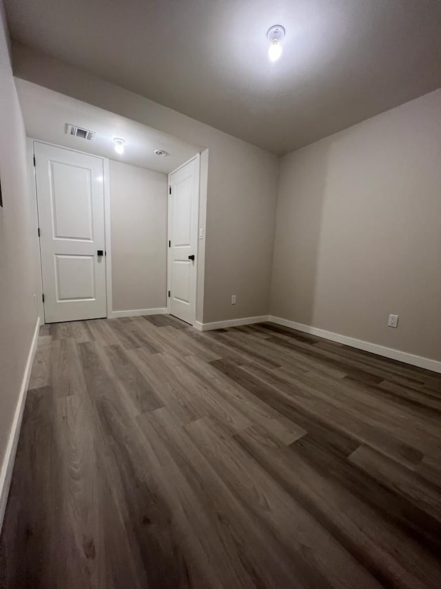 empty room featuring dark wood-type flooring