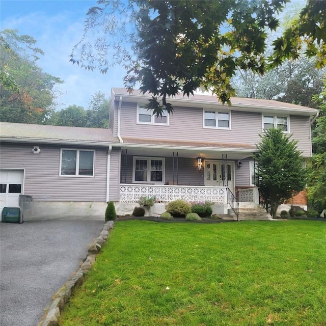 view of front of property with covered porch and a front yard