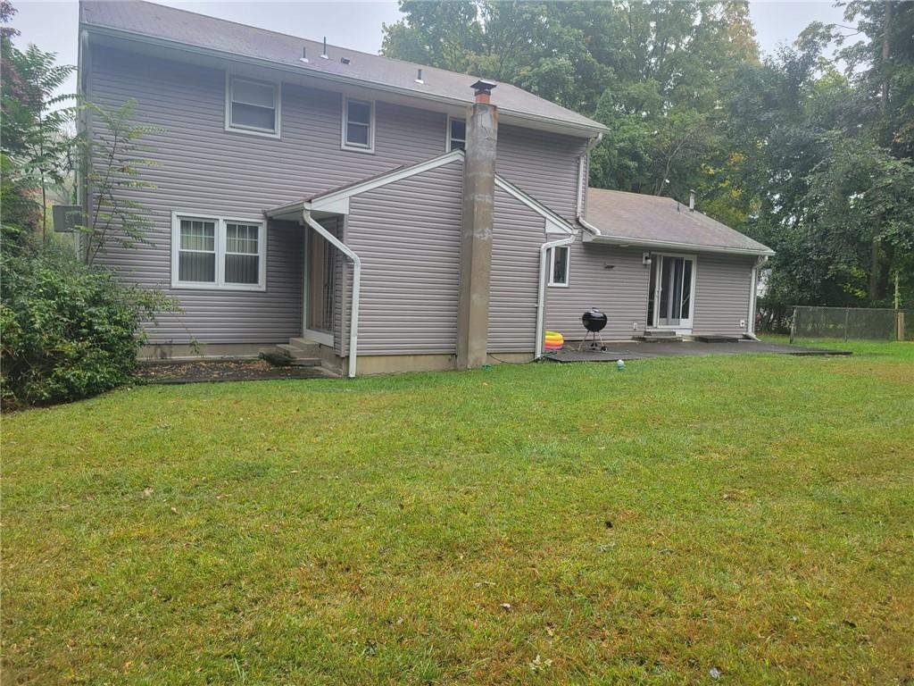 back of house featuring a yard and a patio