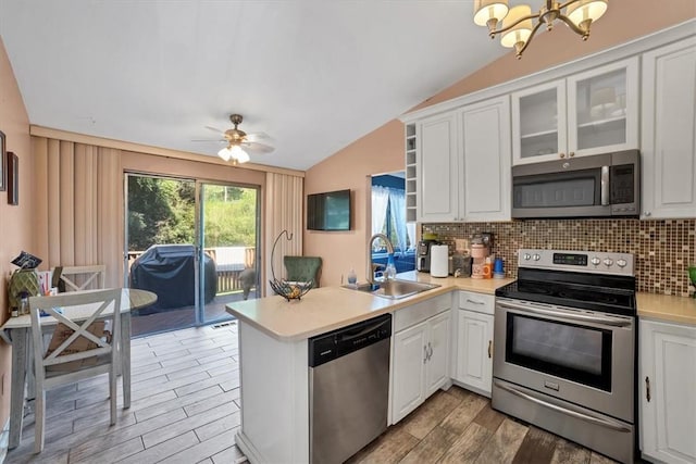 kitchen with white cabinets, sink, kitchen peninsula, and stainless steel appliances