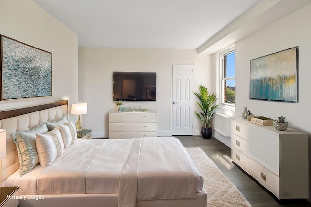 bedroom with dark hardwood / wood-style floors