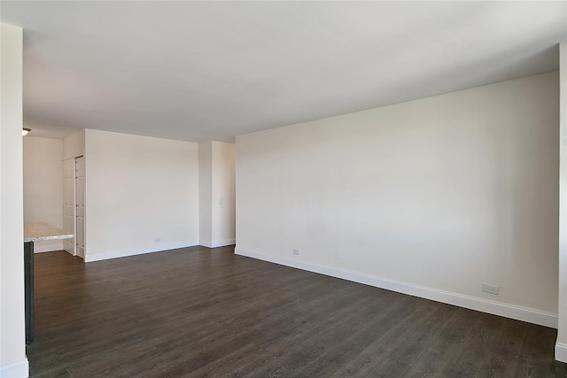 unfurnished room featuring dark hardwood / wood-style flooring