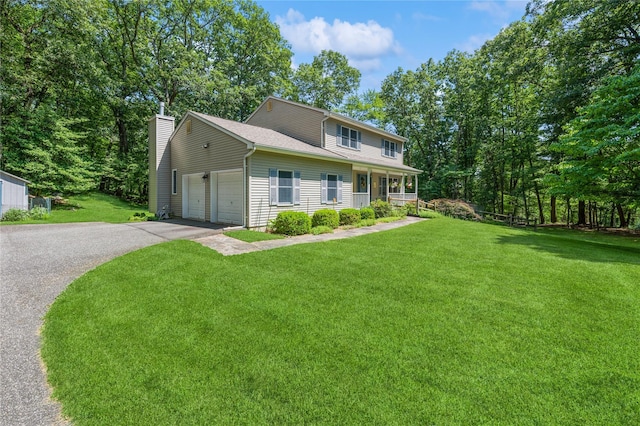 210 Bulsontown Rd, Stony Point, NY 10980 - view of front of home featuring driveway, a front yard, an attached garage, a chimney, and a porch