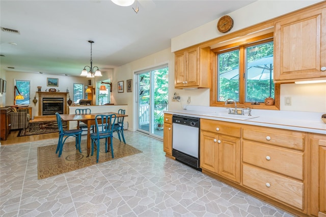 210 Bulsontown Rd, Stony Point, NY 10980 - kitchen featuring dishwasher, light countertops, stone flooring, a glass covered fireplace, and light brown cabinets