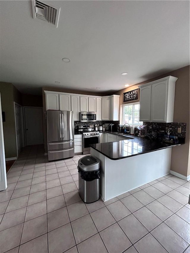 kitchen with white cabinetry and tile walls