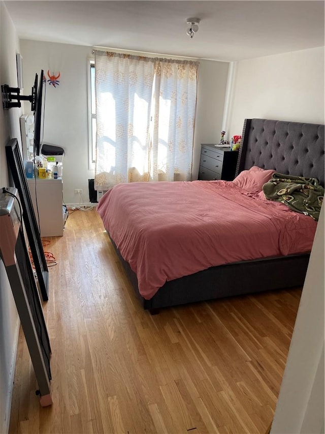 bedroom featuring wooden walls