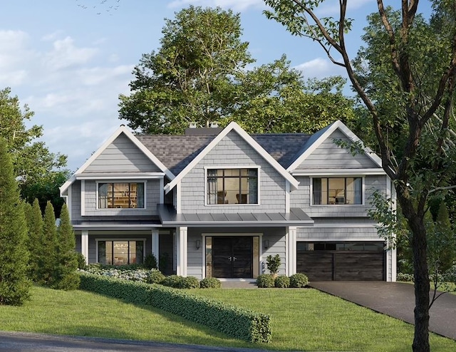 view of front of house featuring a garage and a front yard