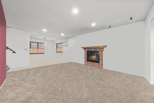 unfurnished living room with light colored carpet and a brick fireplace