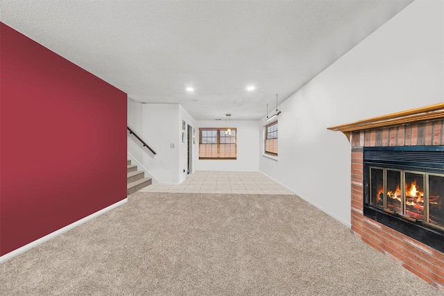 unfurnished living room featuring light colored carpet and a fireplace