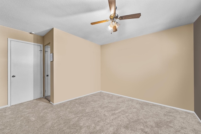 unfurnished bedroom featuring light carpet, a textured ceiling, a closet, and ceiling fan