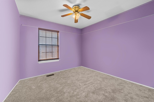 spare room with ceiling fan and carpet floors