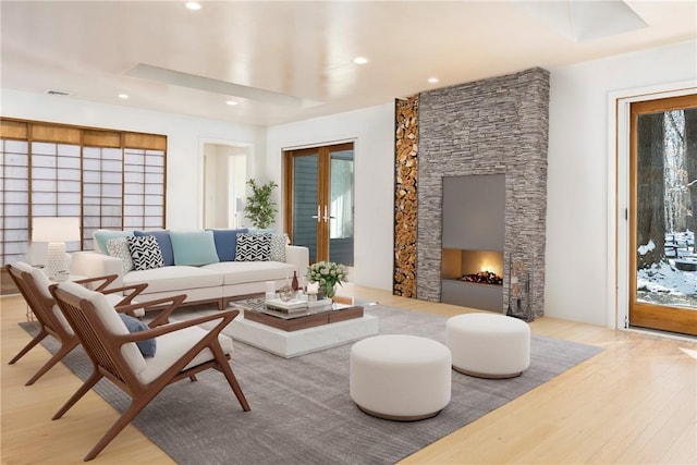 living room with french doors and light wood-type flooring