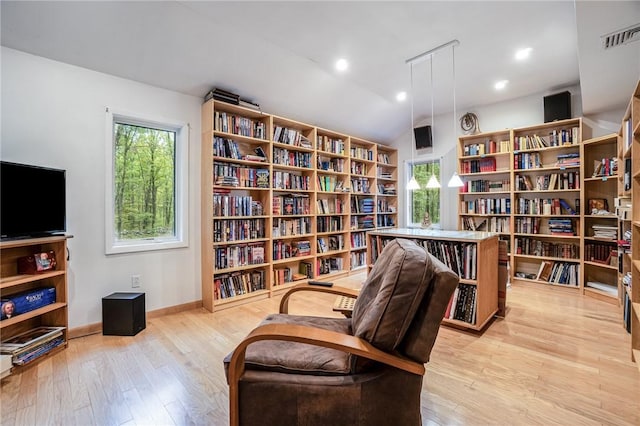 sitting room with vaulted ceiling, light hardwood / wood-style flooring, and a wealth of natural light