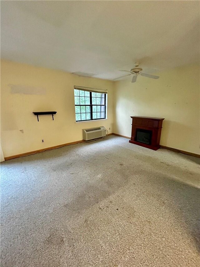 unfurnished living room featuring ceiling fan and carpet floors