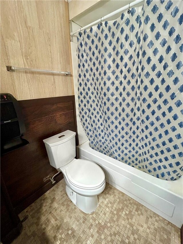 bathroom featuring walk in shower and toilet