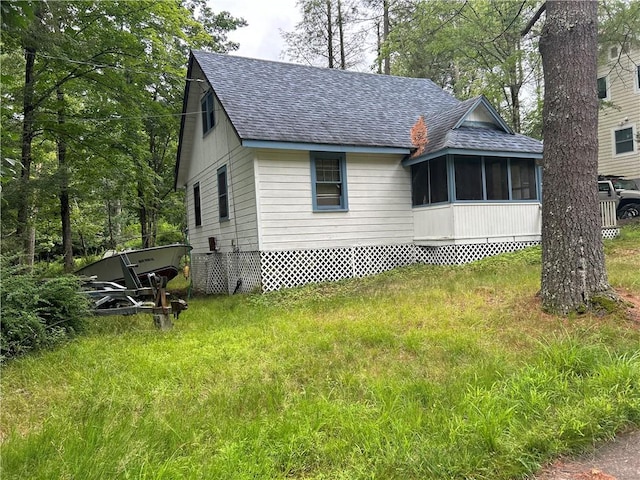 view of home's exterior with a sunroom