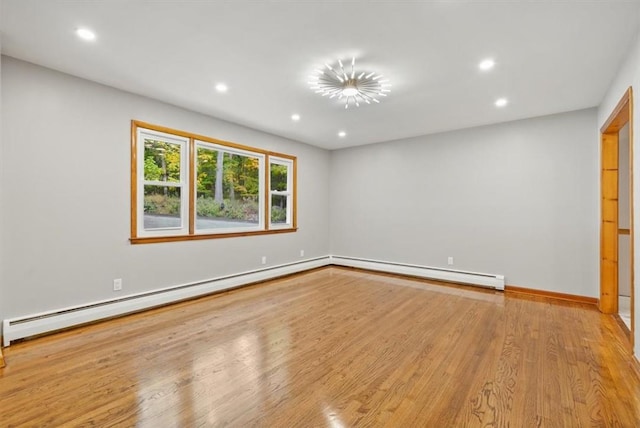 unfurnished room with light hardwood / wood-style floors and a baseboard radiator