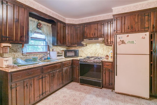 kitchen with dark brown cabinets, white fridge, crown molding, and range with gas cooktop