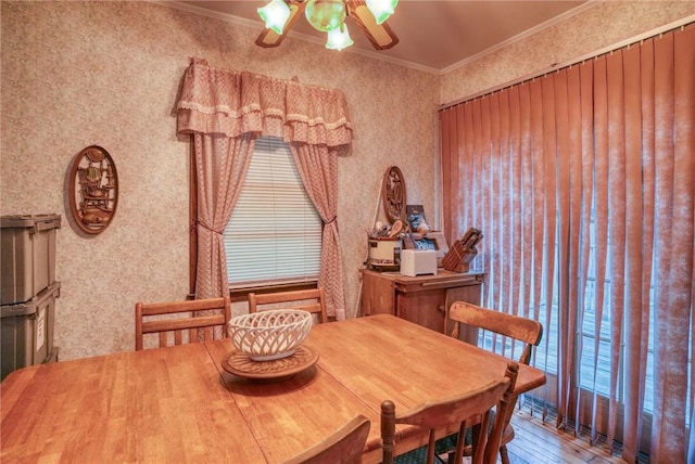 dining area featuring hardwood / wood-style floors, a healthy amount of sunlight, and ornamental molding