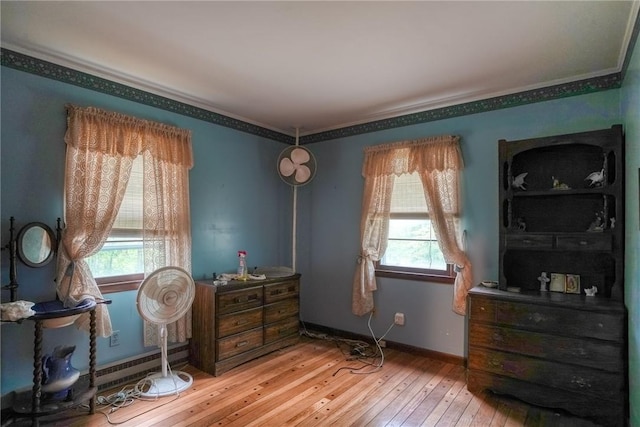 sitting room with crown molding and hardwood / wood-style flooring