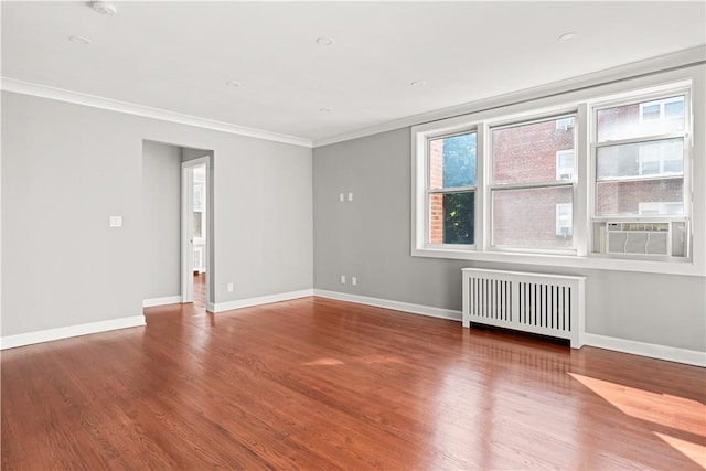 unfurnished room featuring radiator heating unit, hardwood / wood-style flooring, cooling unit, and ornamental molding