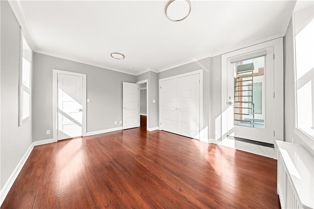 unfurnished bedroom featuring multiple windows, crown molding, and dark hardwood / wood-style floors