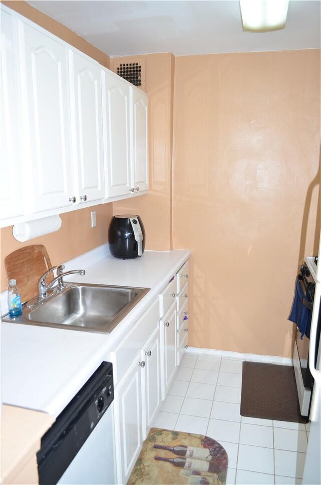 kitchen featuring white cabinets, light tile patterned floors, white appliances, and sink