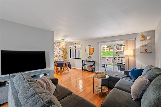 living room with hardwood / wood-style flooring and ceiling fan