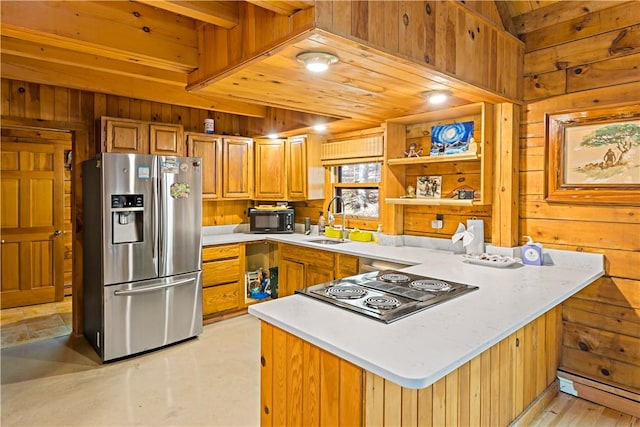 kitchen featuring wood walls, wooden ceiling, sink, appliances with stainless steel finishes, and kitchen peninsula