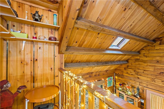 staircase with wooden ceiling, wooden walls, and vaulted ceiling with skylight