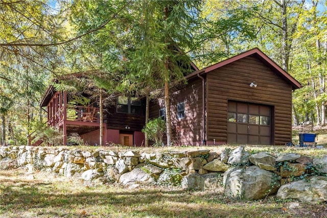 view of front of house with a garage and a deck