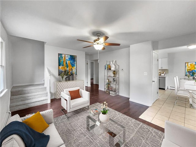 living room featuring hardwood / wood-style flooring, a baseboard radiator, and ceiling fan