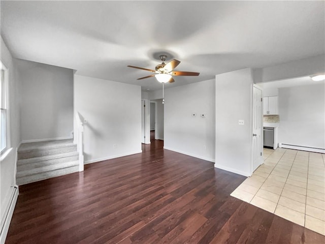 unfurnished living room with ceiling fan, wood-type flooring, and a baseboard heating unit