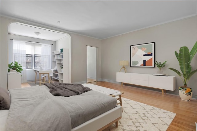 bedroom featuring hardwood / wood-style flooring, a closet, and ornamental molding