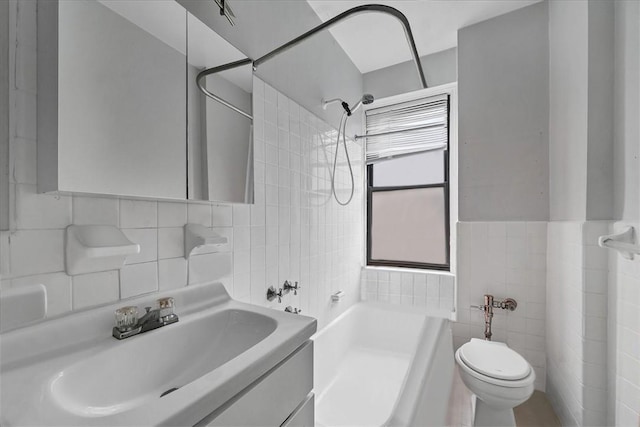 full bathroom featuring bathing tub / shower combination, toilet, tile walls, and sink