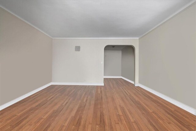 spare room with hardwood / wood-style flooring and ornamental molding