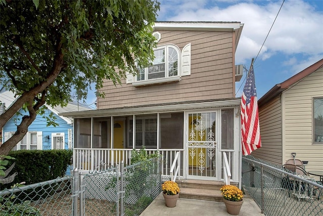 view of front of property with a sunroom