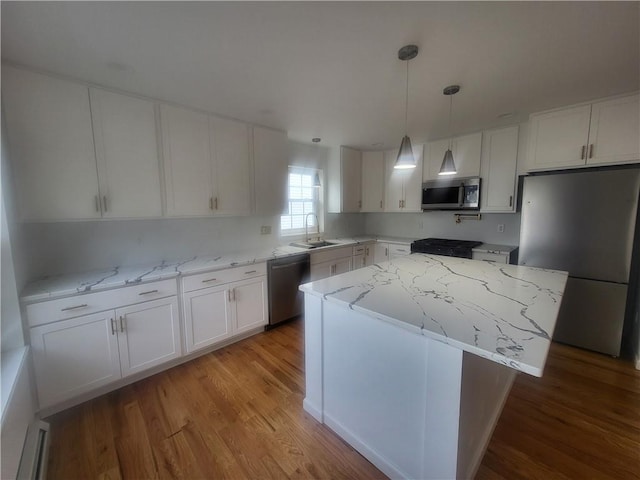 kitchen with light hardwood / wood-style floors, a center island, white cabinetry, and stainless steel appliances