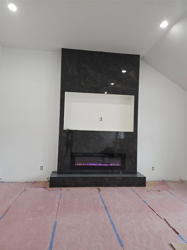 interior details featuring a fireplace and recessed lighting