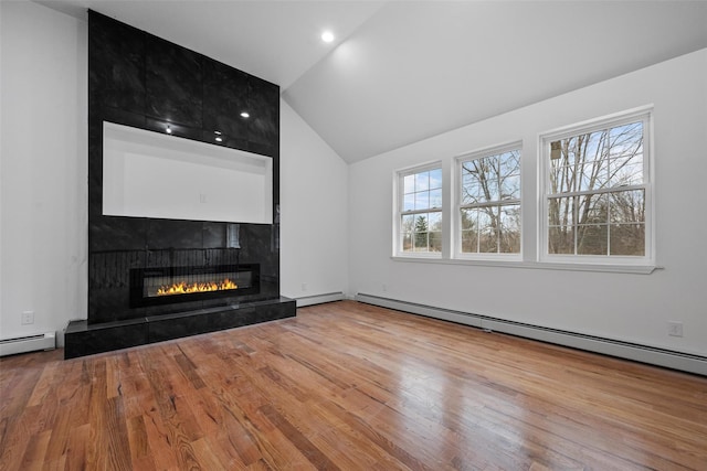 unfurnished living room featuring a baseboard radiator, vaulted ceiling, recessed lighting, a tiled fireplace, and wood finished floors
