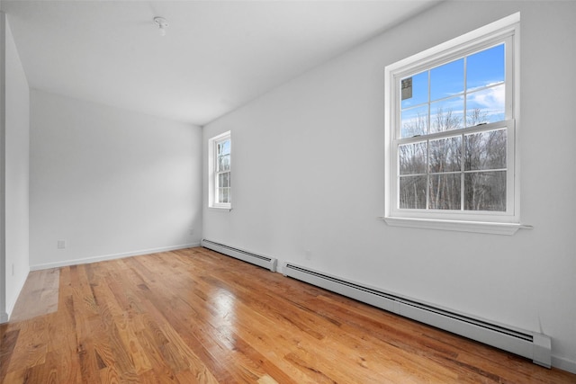 unfurnished room featuring a baseboard radiator and wood finished floors