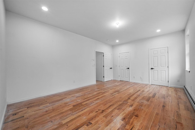 unfurnished bedroom with baseboards, recessed lighting, light wood-type flooring, and a baseboard radiator