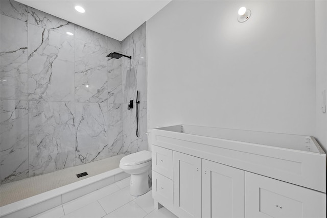 bathroom with a marble finish shower and toilet
