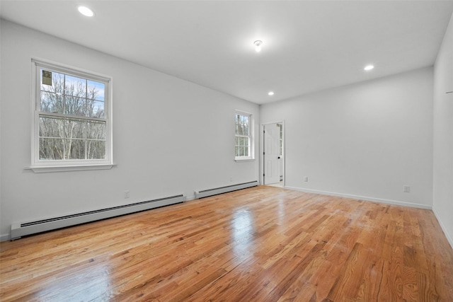 unfurnished room with recessed lighting, baseboards, a baseboard heating unit, and wood finished floors