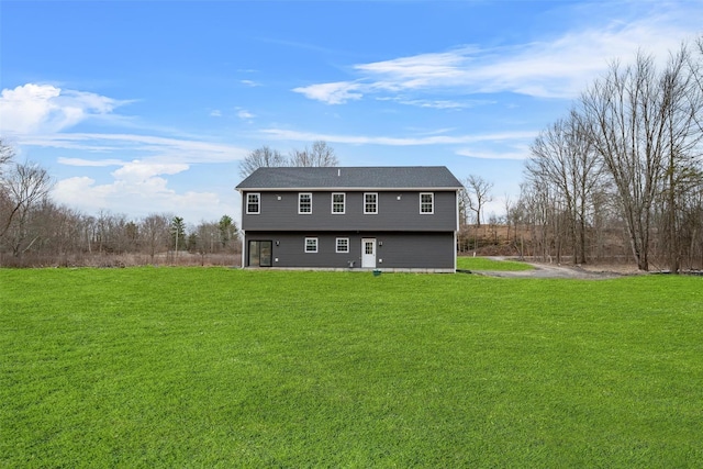 back of property featuring a lawn