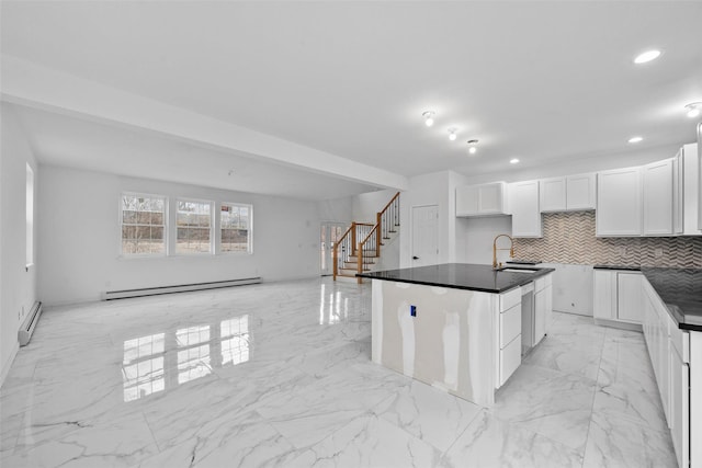 kitchen with backsplash, a sink, white cabinetry, a baseboard radiator, and marble finish floor