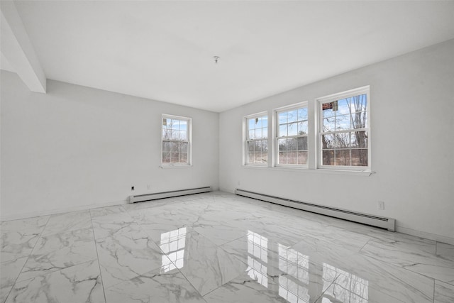 spare room with marble finish floor, baseboards, and baseboard heating
