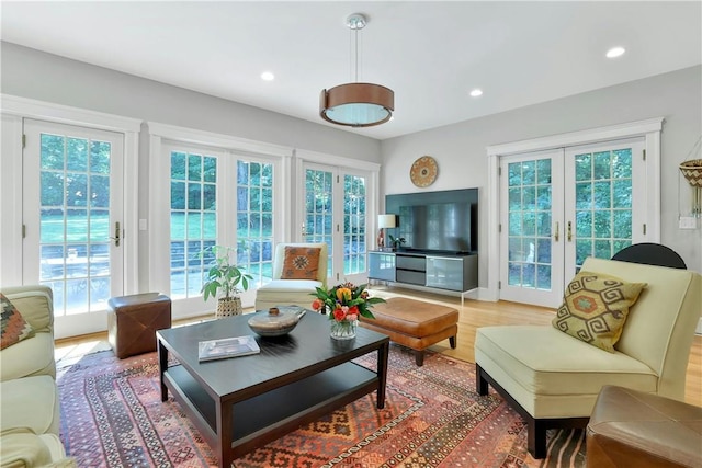 living room with recessed lighting, french doors, and a healthy amount of sunlight